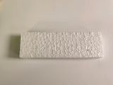 a small white object on a white table