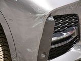 a close up of the front of a car with a dent in it