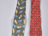pair of neck ties with different designs on them on a white surface