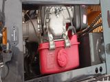 a red container sitting inside of the back of a truck