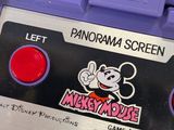 a purple nintendo game console with a mickey mouse sticker on it