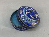 an image of a small blue box with a flower design on it