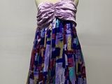 a dress on a mannequin stand with a hat on top of it