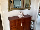 a wooden cabinet with a mirror on top of it
