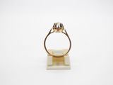 a close up of a ring on a stand with a white background