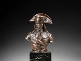 a bronze bust of a man with a hat on a marble base