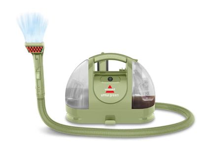 un gros plan d'un aspirateur vert muni d'un tuyau