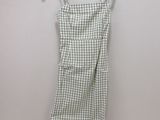 the dress is hanging on a hanger on the wall