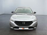 the front view of a silver car parked in a room