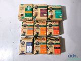 six bags of coffee sit on top of each other on a table
