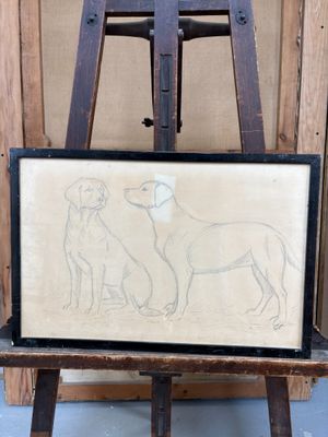 tableau représentant deux chiens posés sur un chevalet devant un mur en bois