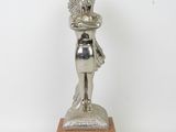 silver statue of a woman holding a baby on a wooden base