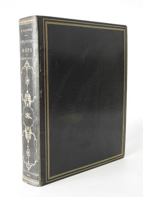 an old black book with gold trim and a black cover