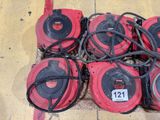 several red and black blowers sitting on the ground next to each other