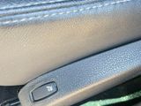 a close up of a car ' s interior with the door handle open