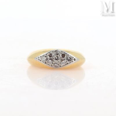 a close up of a diamond ring on a white surface