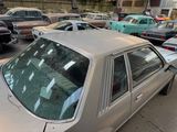 many cars parked in a parking lot next to each other