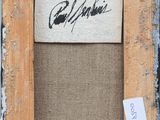 an old picture frame with a piece of paper with a signature on it