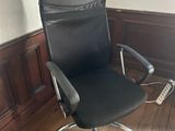 black leather office chair with chrome base and arm rest