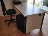 a desk with a chair in front of a sliding glass door