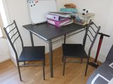 a small table and two chairs in the corner of the room