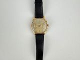 a close up of a watch on a white surface