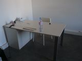un bureau blanc sur lequel se trouve une bouteille d'eau