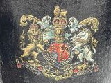 a black vase with a coat of arms and lions on it