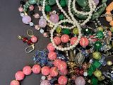 a pile of assorted beads and necklaces on a table