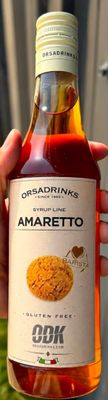 quelqu'un tient une bouteille d'amaretto à la main