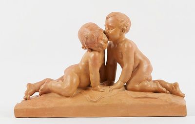 a statue of two children sitting on the ground