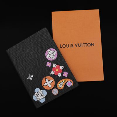 a louis vuitton notebook with flowers and butterflies on it