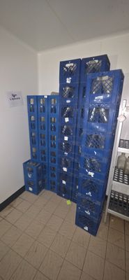 many blue crates stacked on top of each other in a room