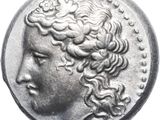 a close up of a silver coin with a woman ' s head on it