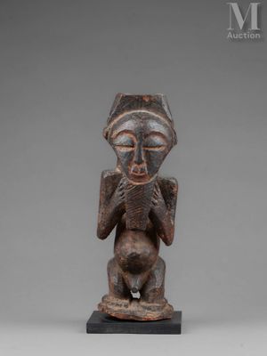 a wooden statue of a man with a hat on his head