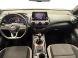 the interior of a small car with a dashboard and steering controls