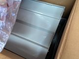 a cardboard box with a piece of metal in it