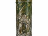 a green vase with a picture of a bird on it