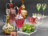 many different colored glass vases and glasses on display
