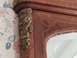 a mirror on the wall with a floral wallpaper behind it
