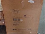 a box that is sitting on the floor in front of a chair