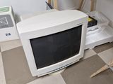 a computer monitor sitting on a desk next to a monitor