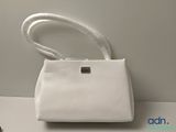 an image of a white purse sitting on top of a table
