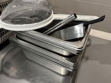 several pans are stacked on top of each other in a kitchen