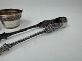 two spoons and a cup sitting on a table