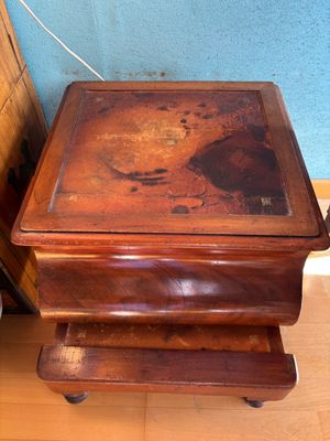 a small wooden table with a drawer underneath it
