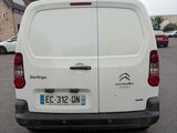 the back of a white van parked in a parking lot