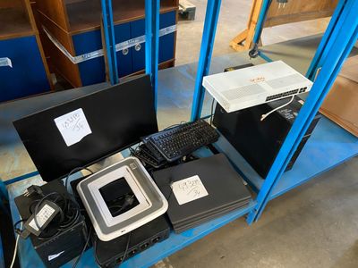 a blue shelf with a computer and other electronics on it