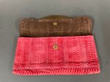two pink and brown purses sitting on top of a table