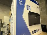 a black and white photo of a printer in a box